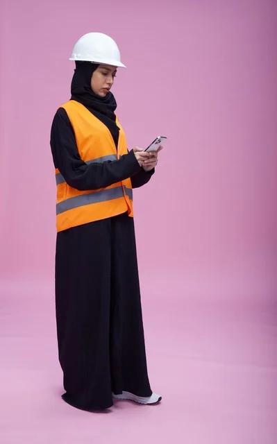 Saudi Female Engineer Using Smartphone in Studio
