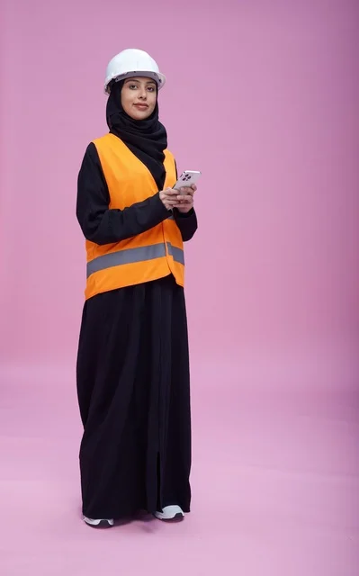 Saudi Female Engineer with Smartphone on Pink Background