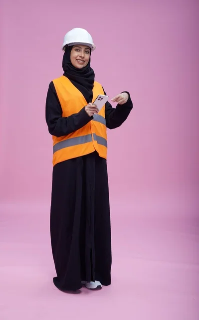 Saudi Female Engineer with Smartphone on Pink Background
