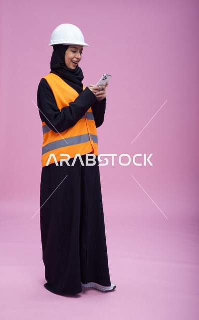 Saudi Female Engineer with Smartphone on Pink Background