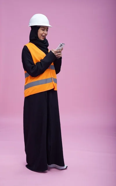Saudi Female Engineer with Smartphone on Pink Background