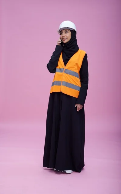 Saudi Female Engineer Talking on Phone in Safety Vest