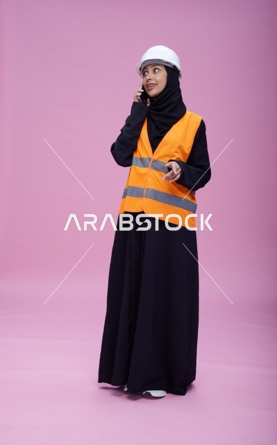 Saudi Female Engineer Talking on Phone in Safety Vest