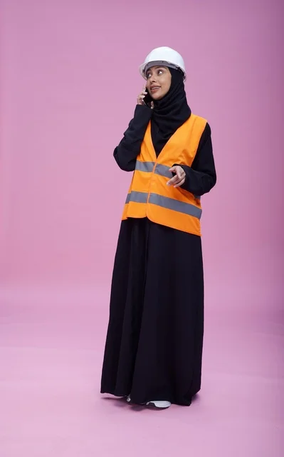 Saudi Female Engineer Talking on Phone in Safety Vest