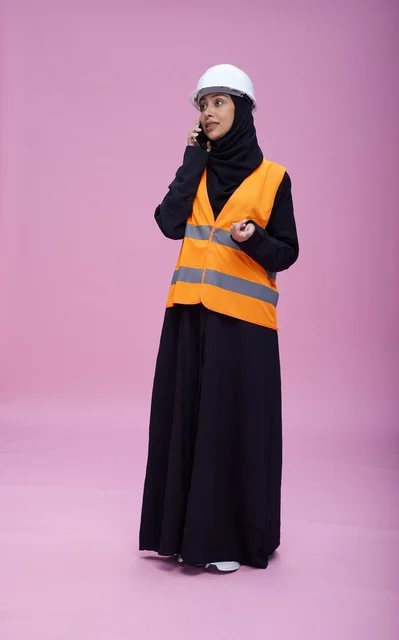Saudi Female Engineer on Phone with Safety Gear