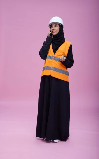 Saudi Female Engineer in Safety Vest Talking on Phone