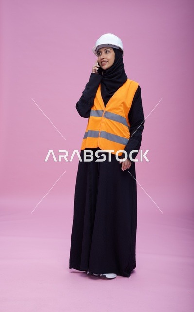 Saudi Female Engineer Talking on Phone Pink Background