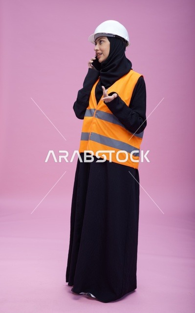 Saudi Female Engineer on Mobile Phone Pink Background