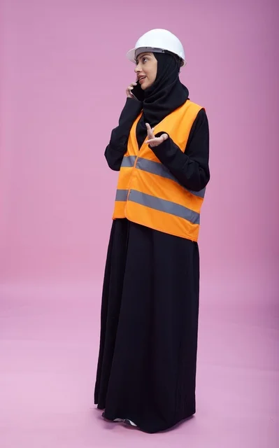 Saudi Female Engineer on Mobile Phone Pink Background