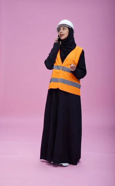 Saudi Female Engineer on Phone with Safety Gear
