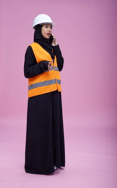 Saudi Female Engineer Talking on Phone Pink Background
