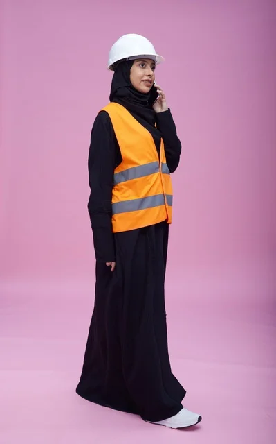 Saudi Female Engineer Talking on Phone Pink Background