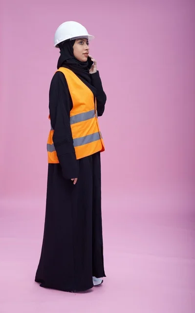 Saudi Female Engineer Talking on Phone in Safety Vest
