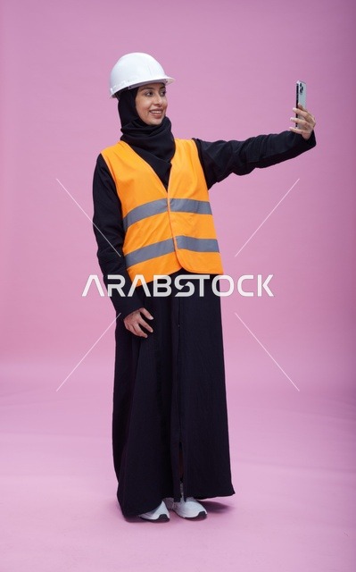 Saudi Female Engineer Selfie with Smartphone Pink Background