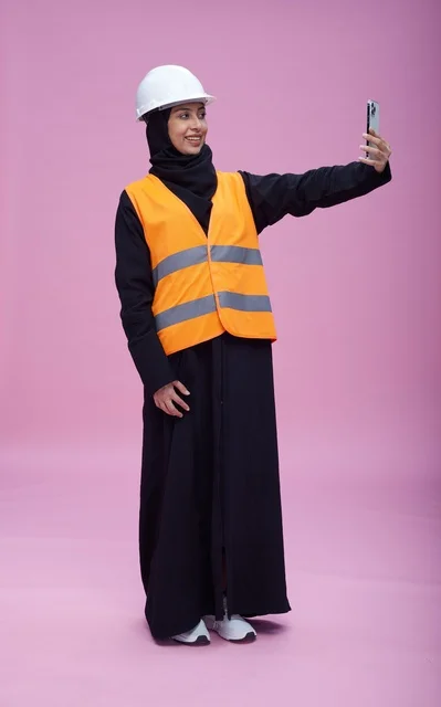 Saudi Female Engineer Selfie with Smartphone Pink Background