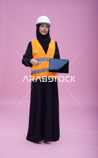 Saudi Female Engineer with Tablet on Pink Background