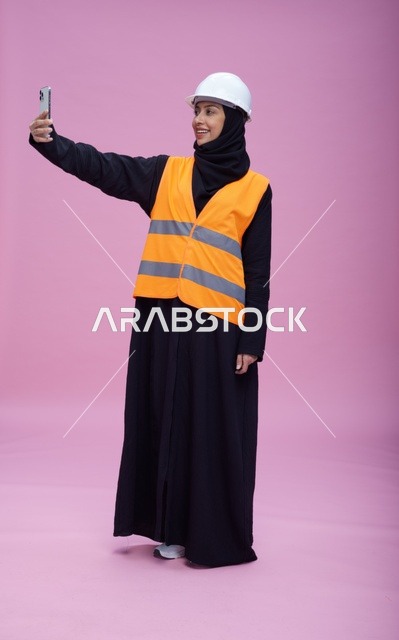 Saudi Female Engineer Taking Selfie on Pink Background