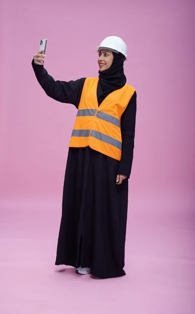 Saudi Female Engineer Smartphone Selfie on Pink Background