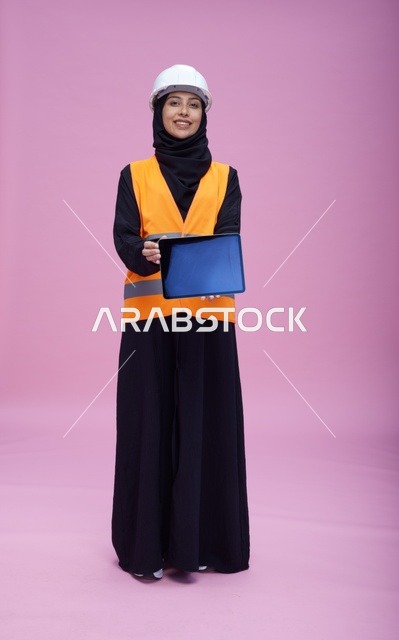 Saudi Female Engineer Holding Tablet on Pink Background
