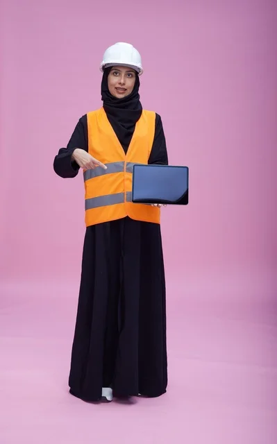 Saudi Female Engineer with Tablet on Pink Background