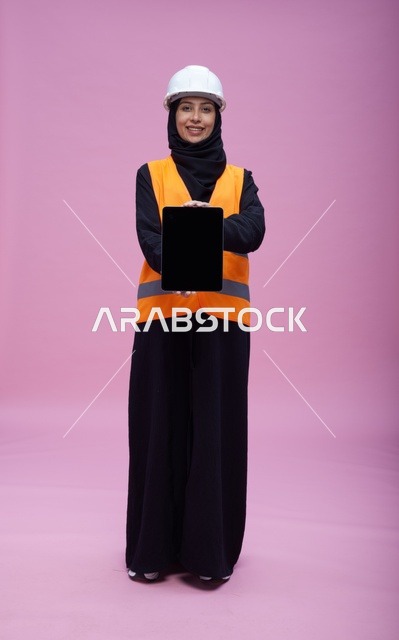 Saudi Female Engineer with Tablet on Pink Background