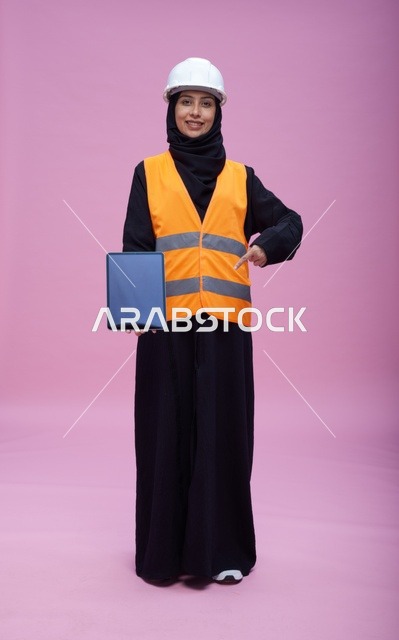 Saudi Female Engineer with Tablet on Pink Background