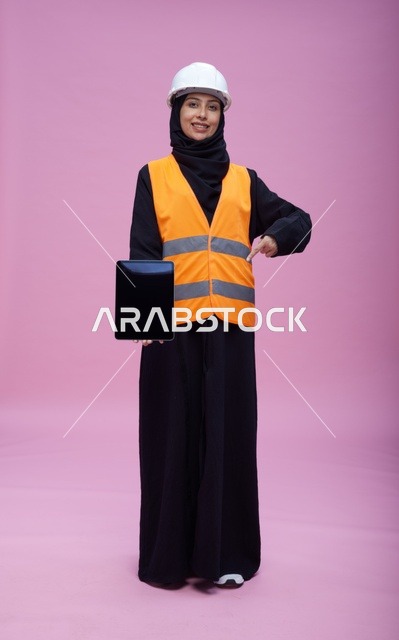 Saudi Female Engineer Holding Tablet on Pink Background
