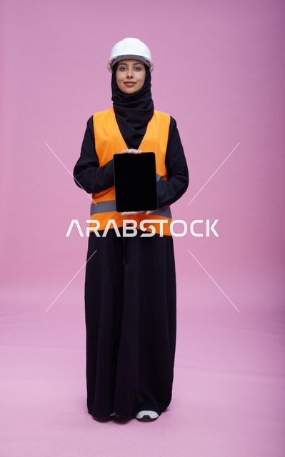 Saudi Female Engineer Holding Tablet on Pink Background