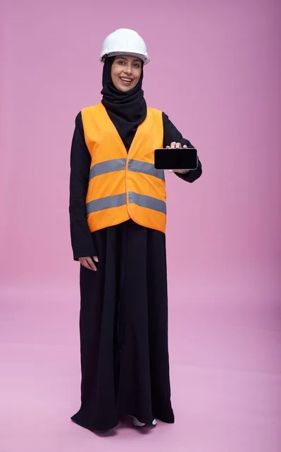 Saudi Female Engineer Holding Smartphone on Pink Background