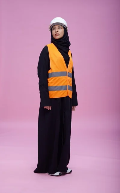 Saudi Female Engineer in Safety Vest on Pink Background