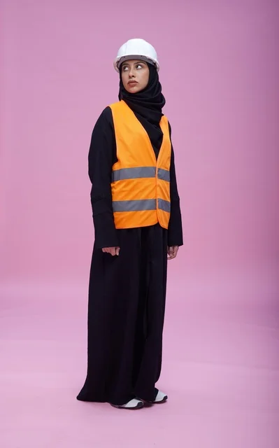 Saudi Female Engineer in Safety Vest on Pink Background