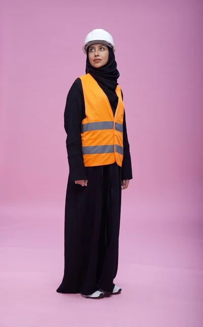 Saudi Female Engineer in Safety Gear on Pink Background