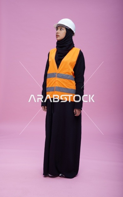 Saudi Female Engineer in Safety Gear on Pink Background