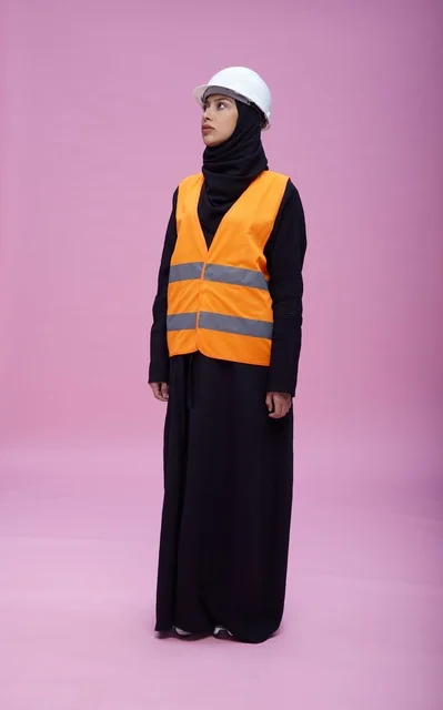 Saudi Female Engineer in Safety Gear on Pink Background