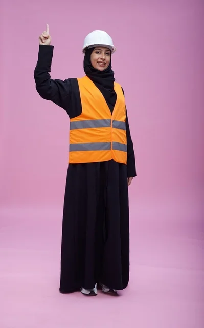 Saudi Female Engineer in Safety Gear Pointing Up