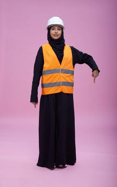 Saudi Female Engineer in Safety Gear Pointing Down