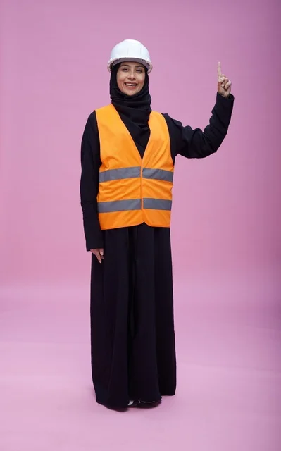 Saudi Female Engineer in Safety Gear on Pink Background
