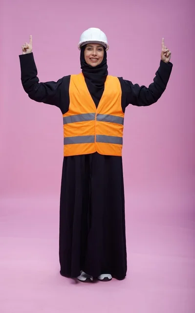 Saudi Female Engineer in Safety Vest Pointing Up