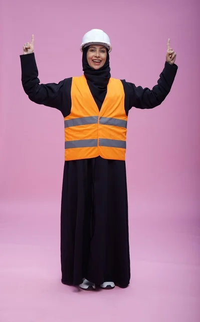 Saudi Female Engineer in Safety Gear on Pink Background