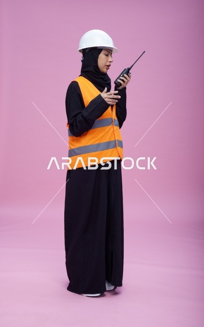 Saudi Female Engineer with Walkie Talkie on Pink Background