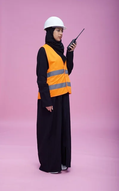 Saudi Female Engineer with Walkie-Talkie on Pink Background