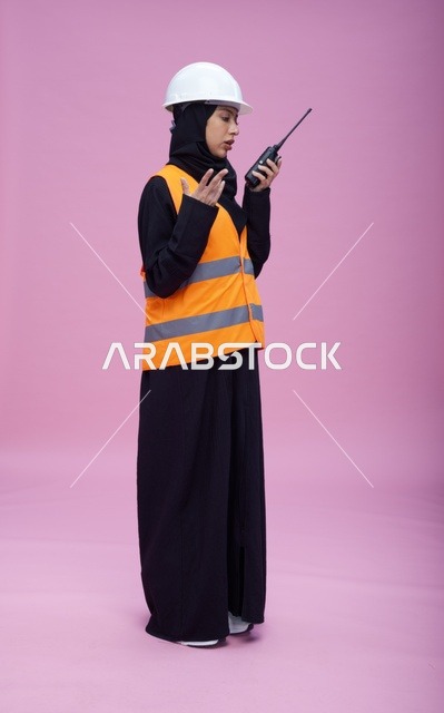 Saudi Female Engineer Using Walkie-Talkie in Studio