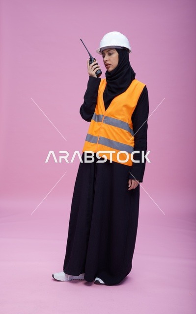 Saudi Female Engineer with Radio in Safety Gear
