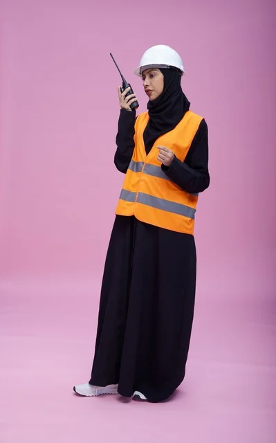 Saudi Female Engineer with Walkie-Talkie on Pink Background