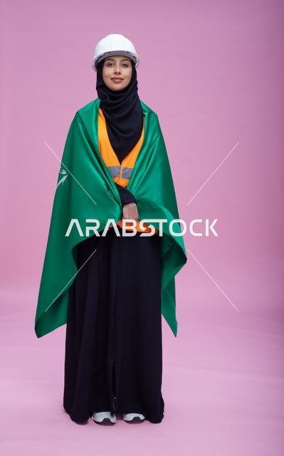 Saudi engineer holding the Saudi flag