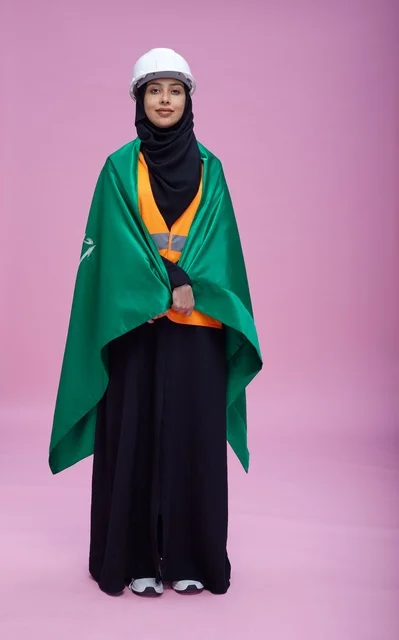 Saudi engineer holding the Saudi flag