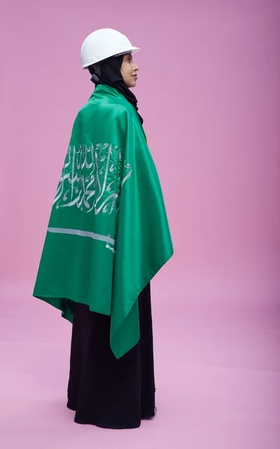 Saudi Female Engineer with Flag and Safety Helmet