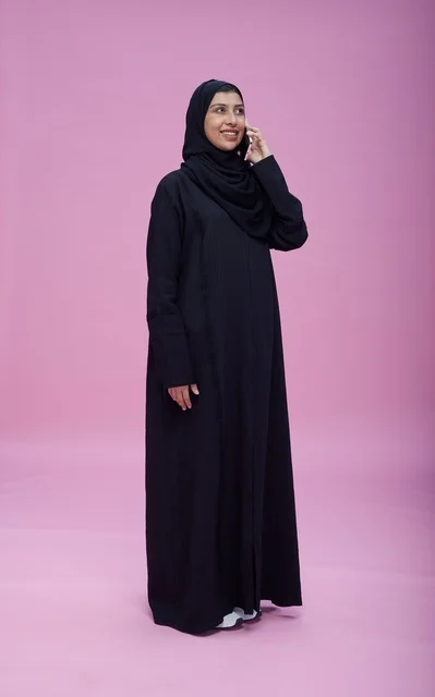 Saudi Woman in Black Abaya Using Smartphone