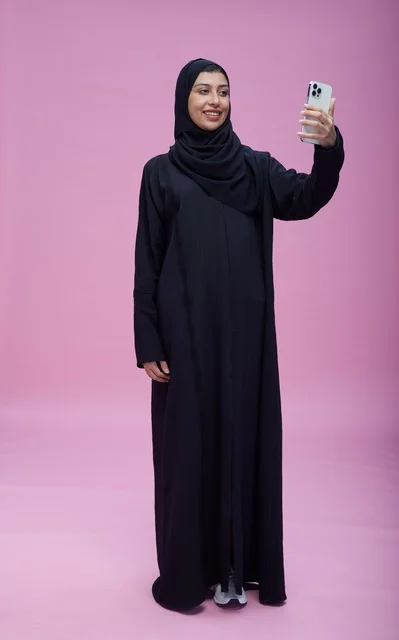 Saudi Woman Taking Selfie on Pink Background