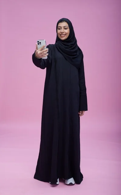 Saudi Woman Taking Selfie on Pink Background